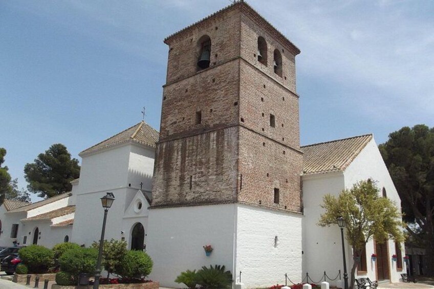 A church with a bell tower, white walls, and a tiled roof. 3