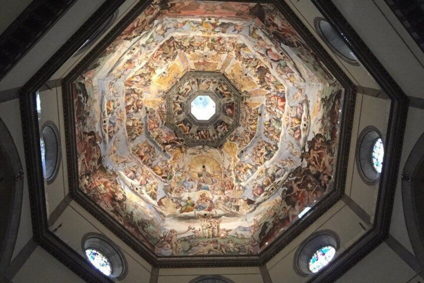 A detailed octagonal ceiling with intricate frescoes and a central circular design. 4