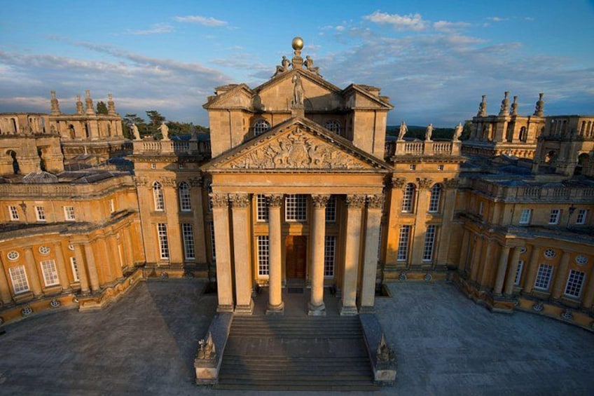 A grand classical building with columns, a central entrance, and a symmetrical facade. 1
