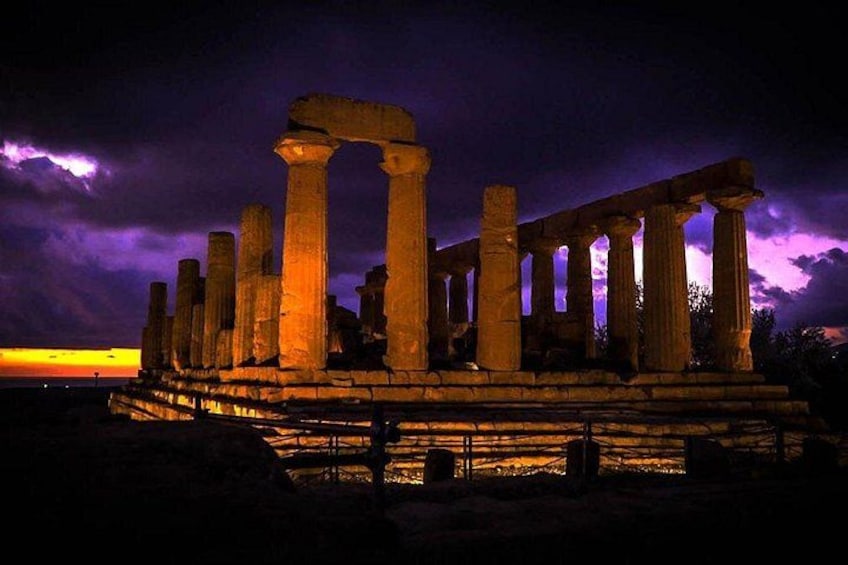 Ancient ruins with columns illuminated at night. 4