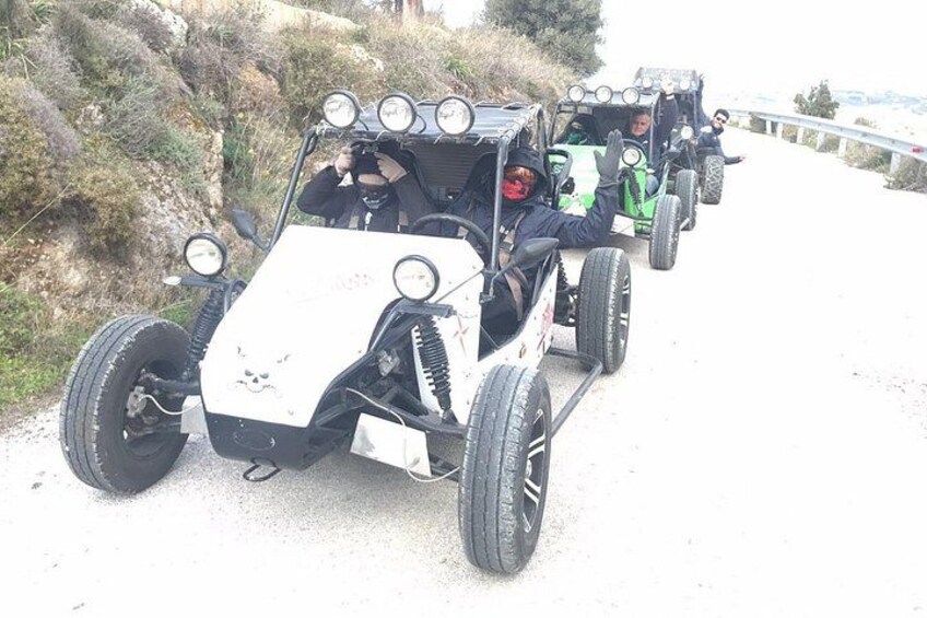 A convoy of off-road vehicles on a dirt road. 2