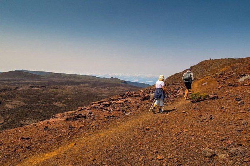 Two hikers on a rocky trail with a mountainous landscape in the background. 4