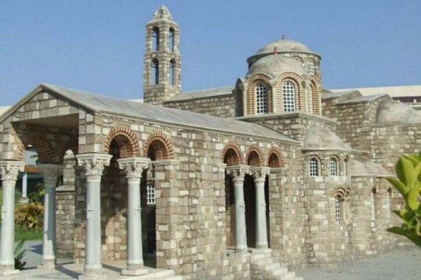 A historic stone building with arches, columns, and a bell tower. 2