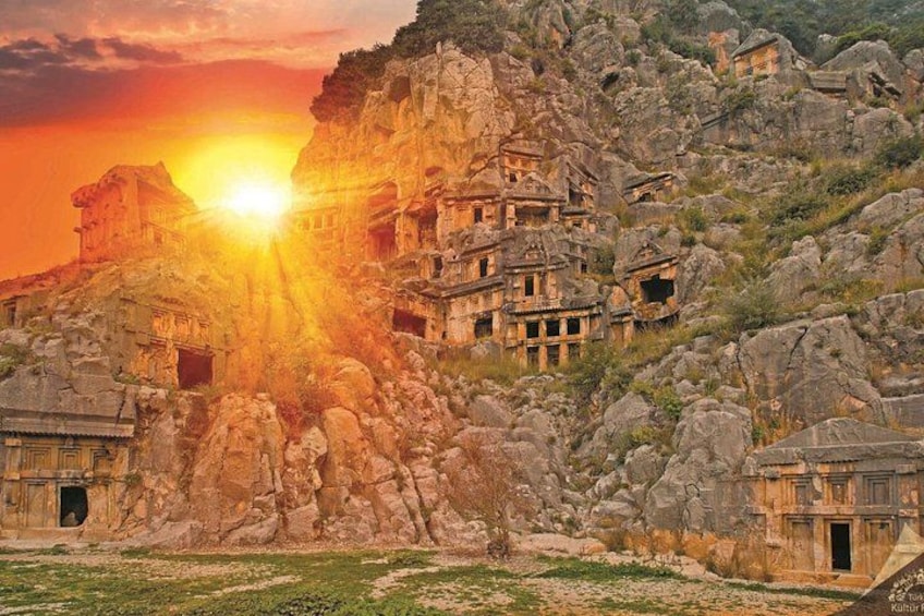 Ancient ruins with a sun setting behind them. 1
