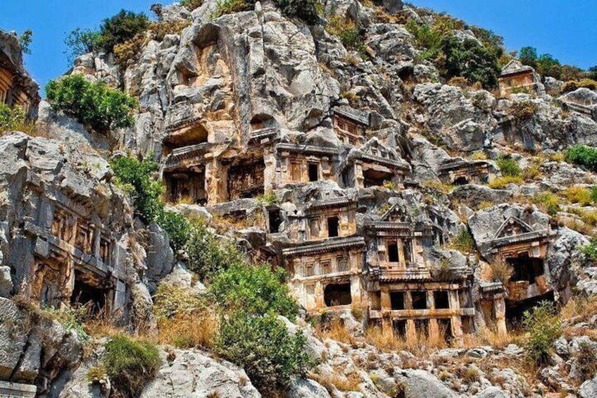 Ancient rock-cut tombs on a hillside. 2