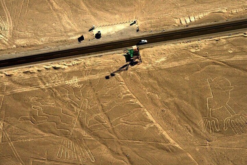 A desert landscape with large sand dunes and a person riding a camel. 5