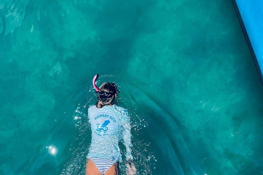 A person snorkeling in clear blue water. 3