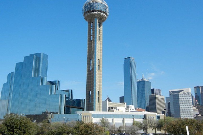 A cityscape with a prominent tower and modern skyscrapers. 1