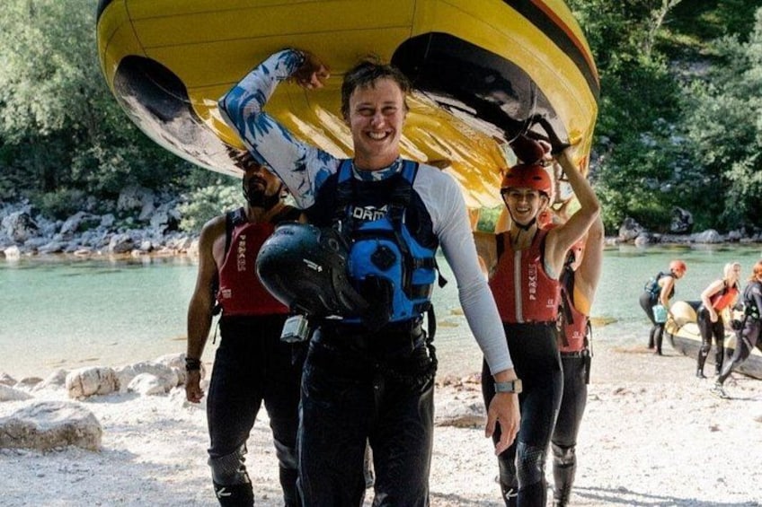 A person carrying a large yellow and black parachute, wearing a blue life jacket, and another person in a red life jacket in the background. 4