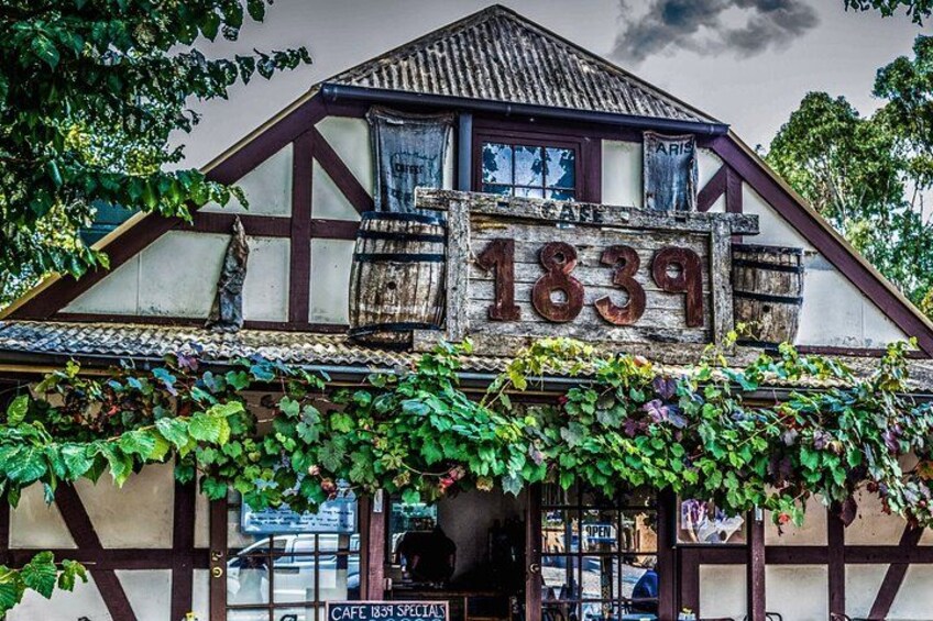 A building with a sign reading '1839' and a sign below it that says 'Cafe 1839 Specials.' 5