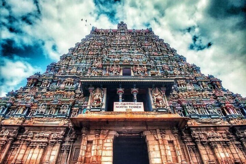 A temple with intricate carvings and a sign reading 'NORTH TOWER'. 4
