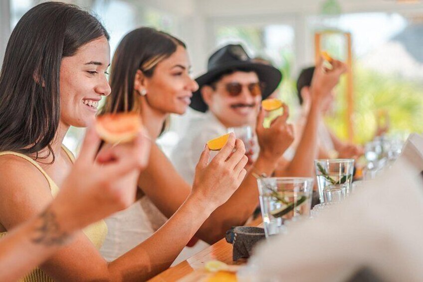 People sitting at a table with food and drinks. 1
