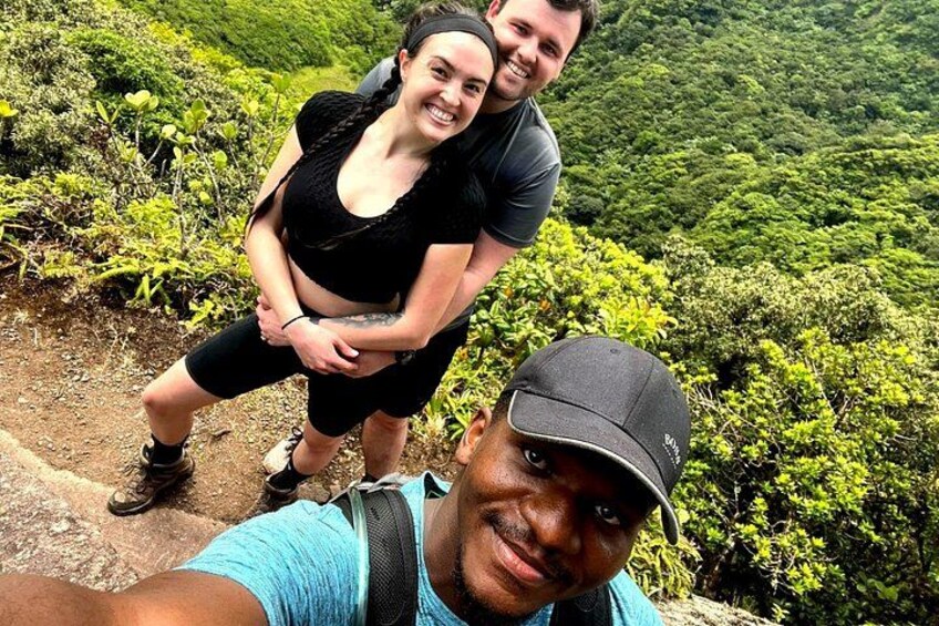 A person taking a selfie with a mountainous landscape in the background. 5