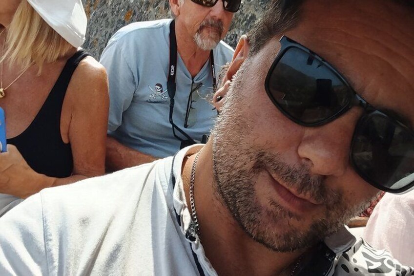 A person wearing a white shirt and sunglasses. 4