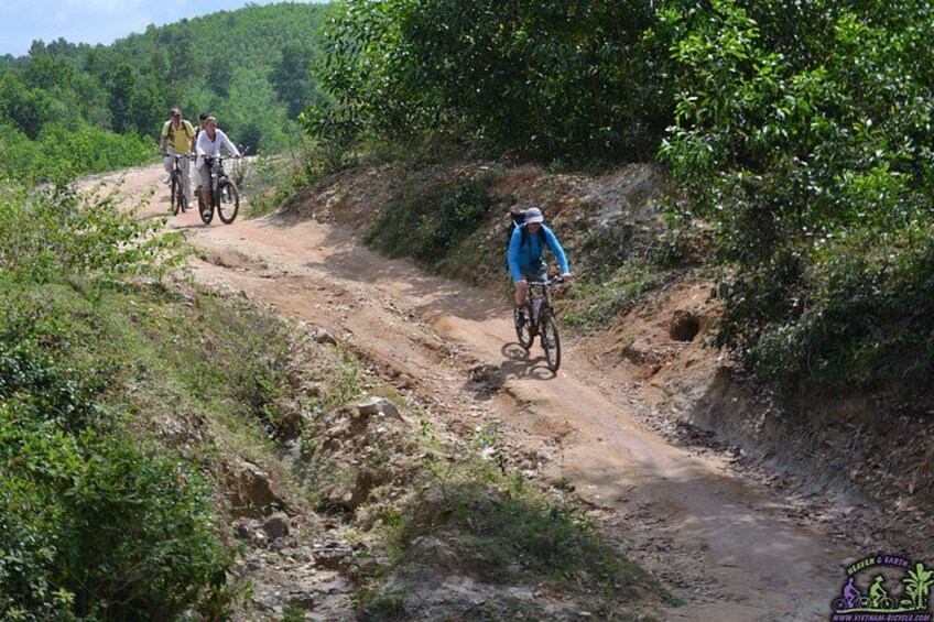 A dirt path with cyclists. 1