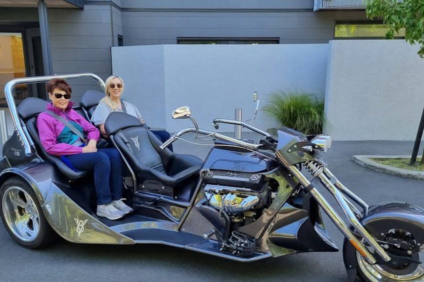 A three-wheeled motorcycle with two passengers. 4