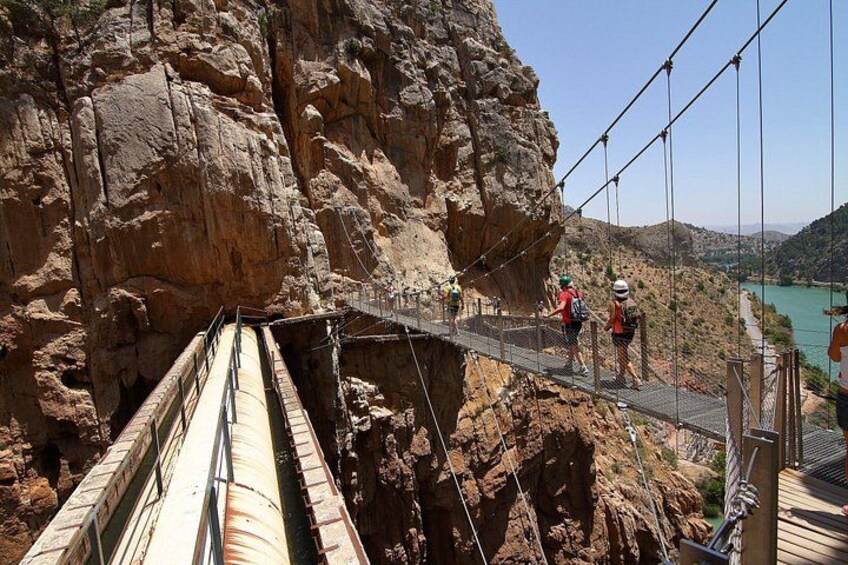 A suspension bridge with hikers. 5
