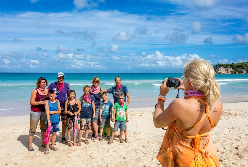 A group of people on a beach with the ocean in the background. 2