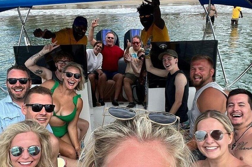A group of people on a boat with water in the background. 1