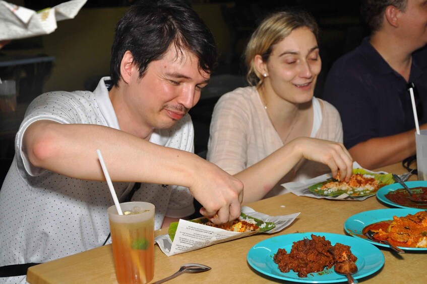 People dining at a restaurant with various dishes on plates. 3