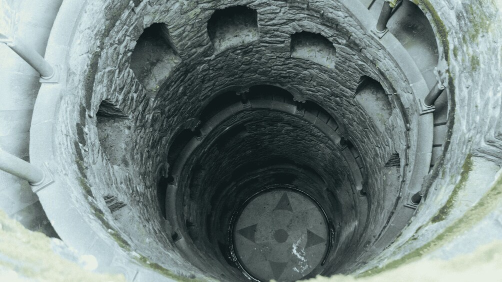 A stone spiral staircase with a star pattern at the center. 5