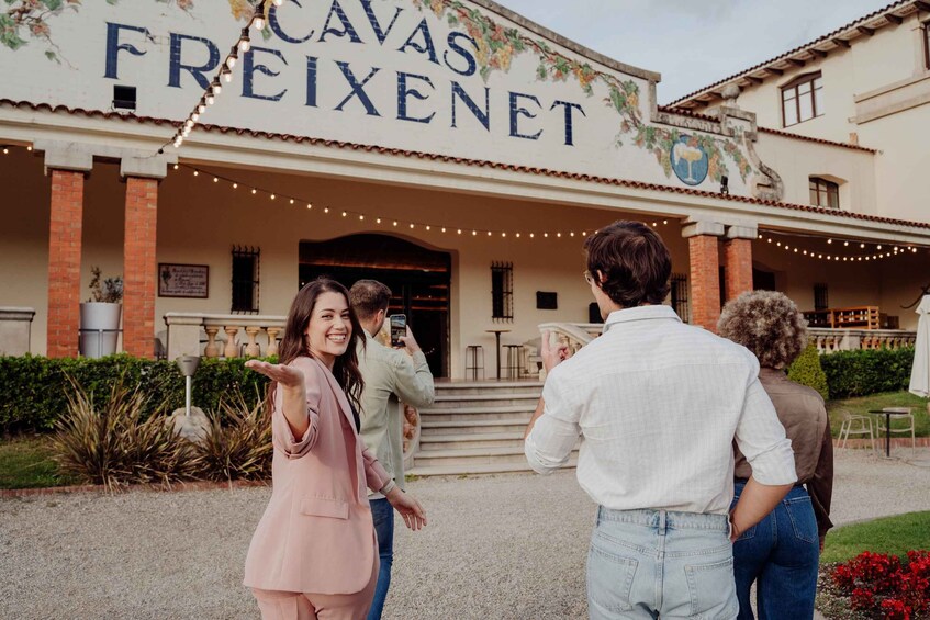 A building with 'CAVAS FREIXENET' signage, outdoor seating, and string lights. 5