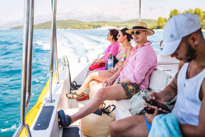 People on a boat with a view of the sea and a distant shoreline. 5
