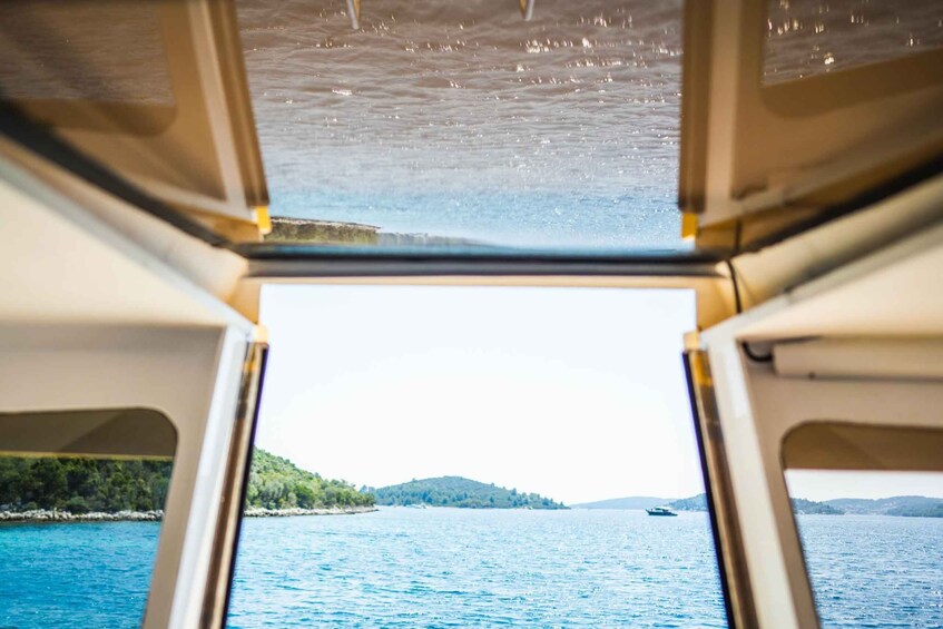 A view from a boat looking out over a calm sea with a distant shoreline. 4