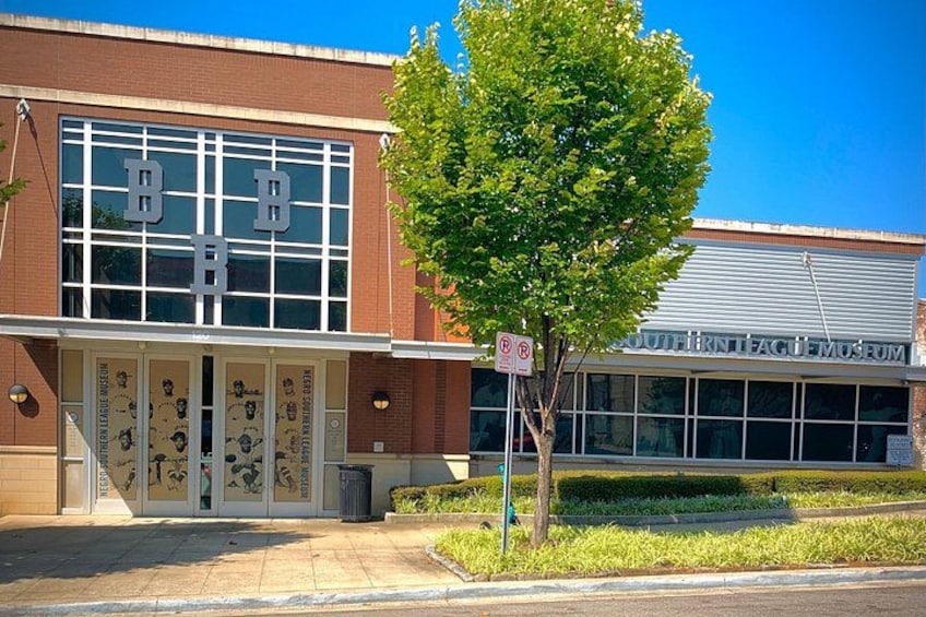 A building with large windows and a tree in front. 4