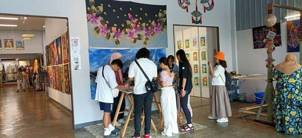 A group of people in an art gallery, some are painting, others are observing. 2