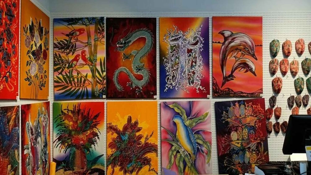 A wall of colorful paintings, including birds, a dragon, and a dolphin. 3