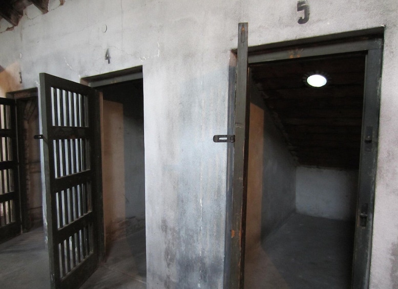 Three open metal doors with a concrete wall, numbered 4 and 5. 2