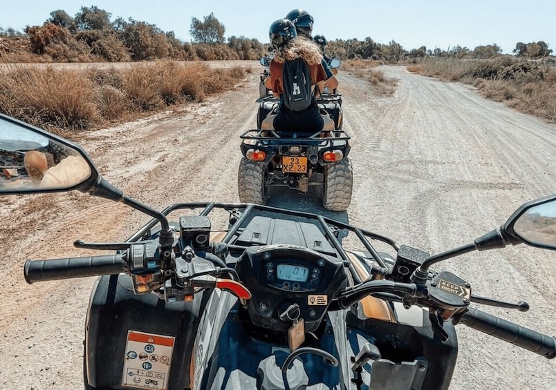 A dirt road with two off-road vehicles. 3