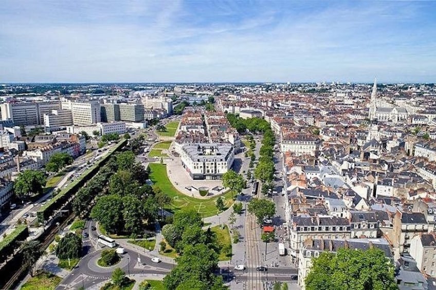 Panorama urbano con un edificio storico di rilievo, un grande parco verde e una zona densamente popolata con edifici moderni. 3