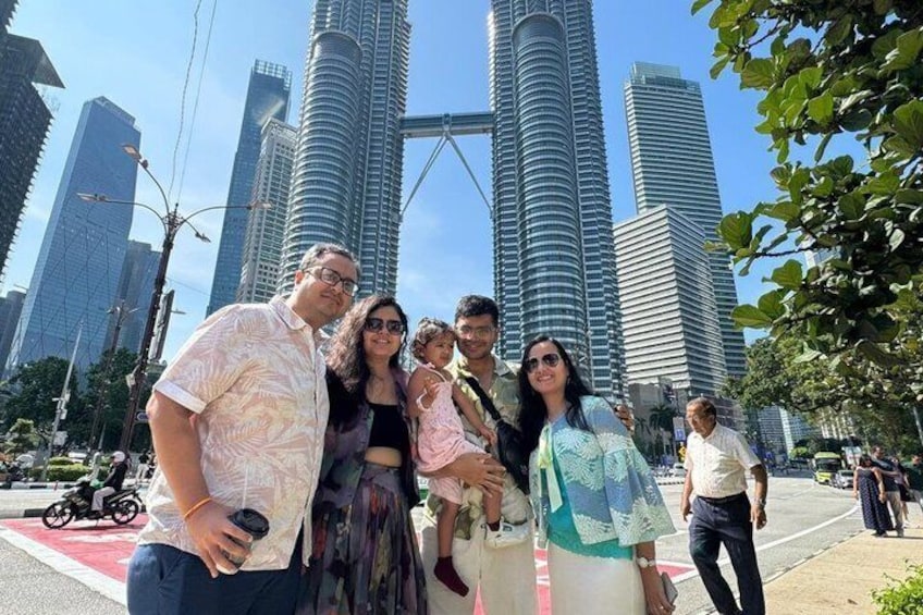 A group of people posing in front of tall skyscrapers. 5