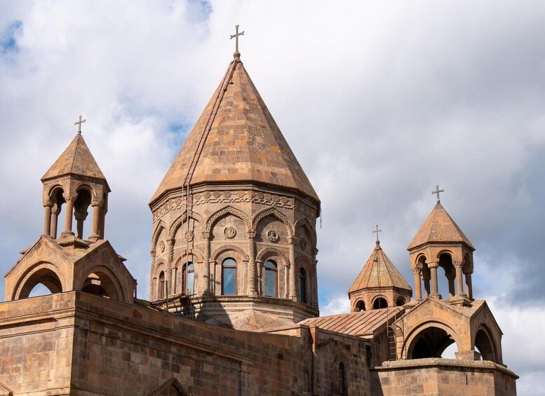 A historic church with a central dome and four smaller domes, each topped with a cross. 1