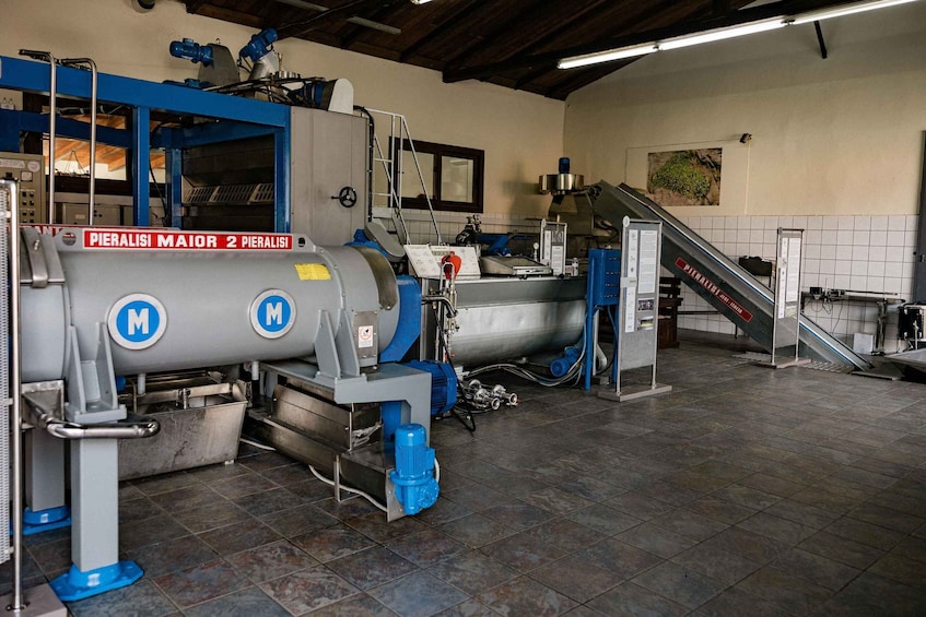 A large industrial machine labeled 'PIERALISI MAIOR 2 PIERALISI' in a factory setting. 4