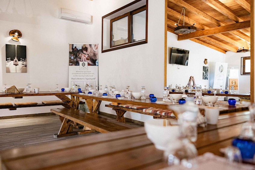 A wooden table with blue and white glassware and a poster on the wall. 5