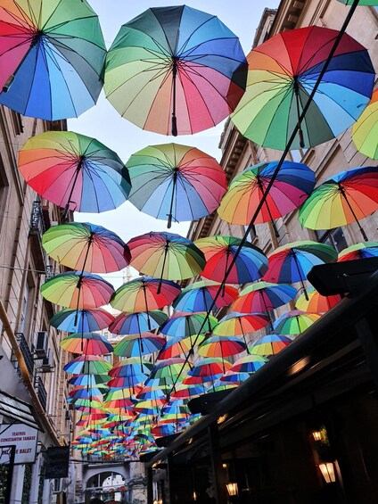 A street lined with colorful umbrellas. 4