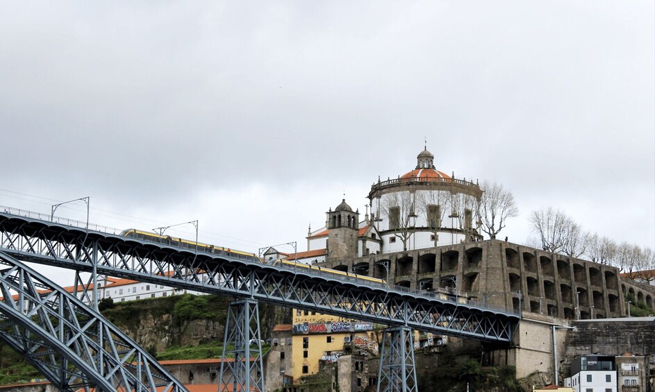 A bridge with a train crossing over a historic building with a dome. 3