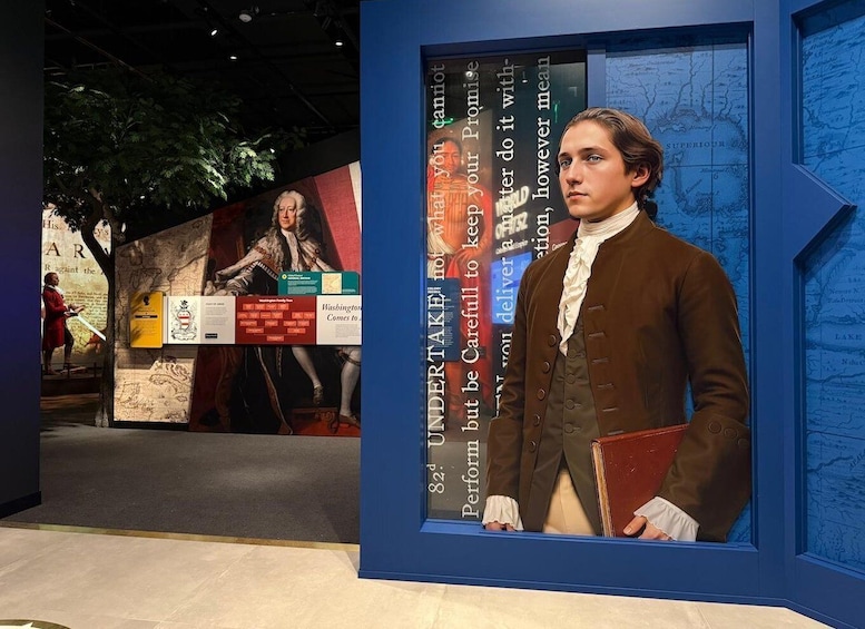 A historical exhibit with a figure in period clothing, a map, and informational panels. 2