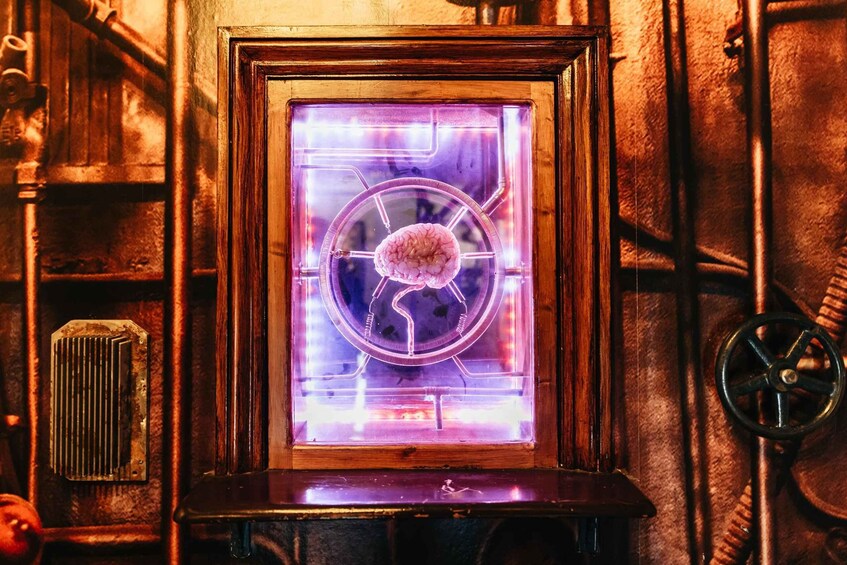 A framed picture of a brain with a glowing outline, set against a rustic background with pipes and a radiator. 5