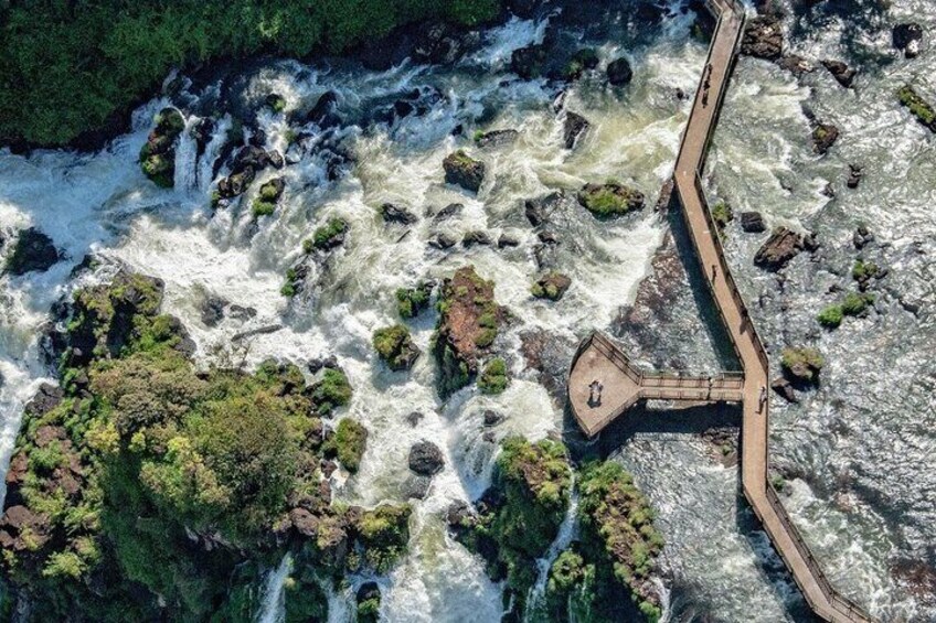 A river with a wooden walkway and a lookout point. 3