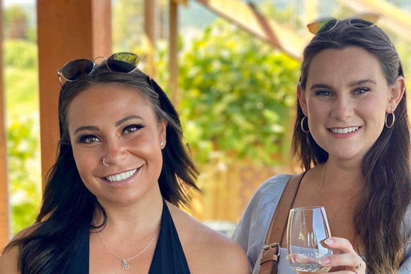 Two individuals outdoors, one holding a glass. 4
