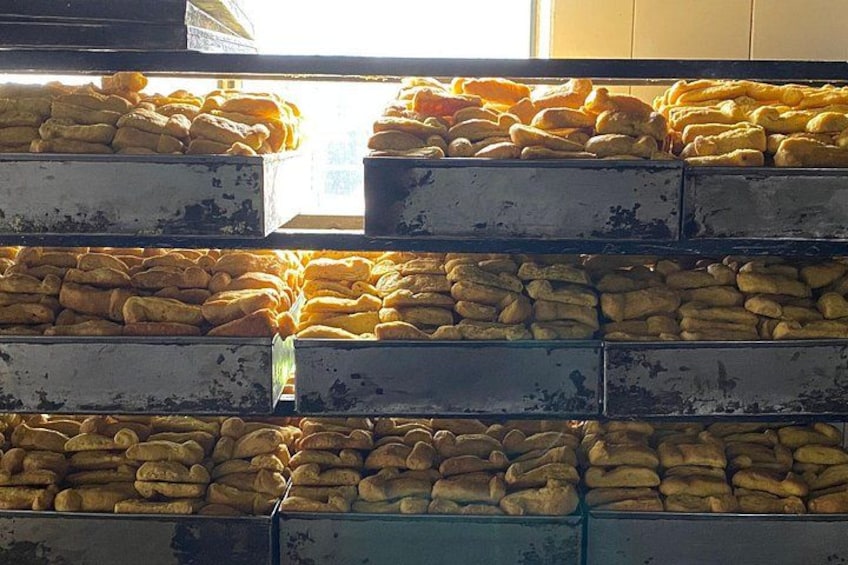 Stacks of baked goods in metal bins. 5