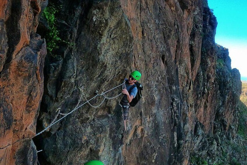 A person rappelling down a steep cliff. 3
