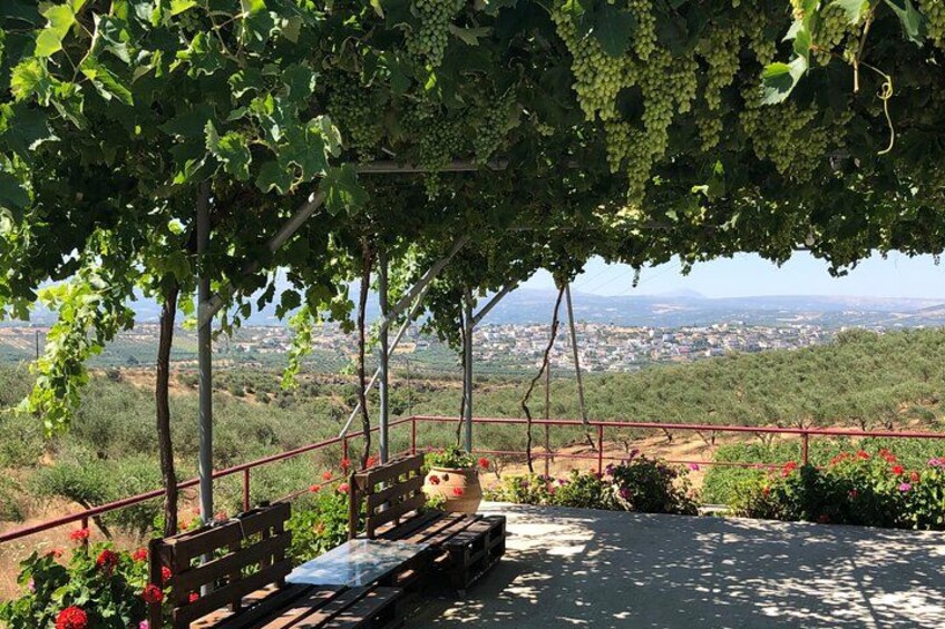 A covered seating area with a view of a city in the distance. 2