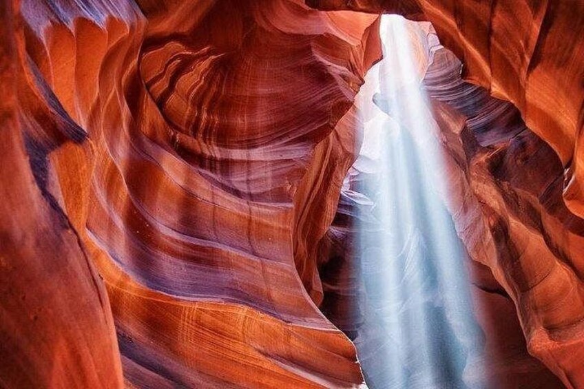 A canyon with red rock formations and a narrow water channel. 2