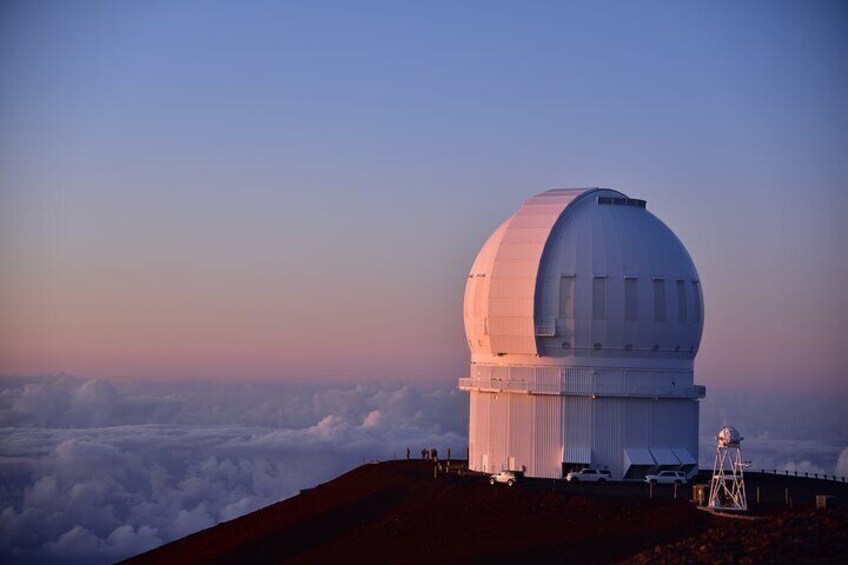 A large observatory dome on a hill with a clear sky. 5