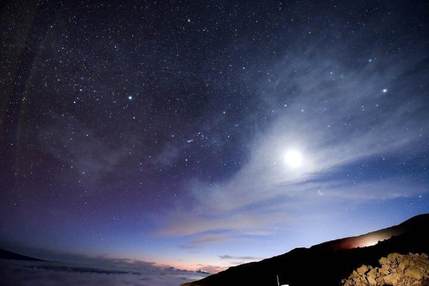 A starry night sky over a mountainous landscape. 3
